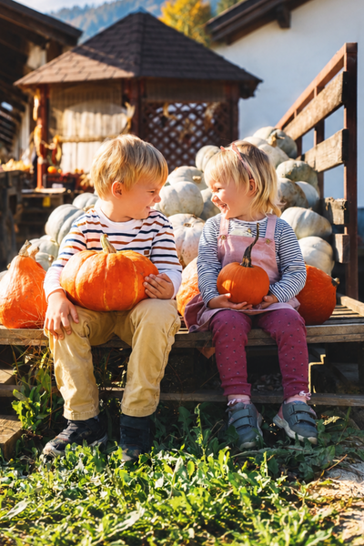 children-smiling-with-pumpkins