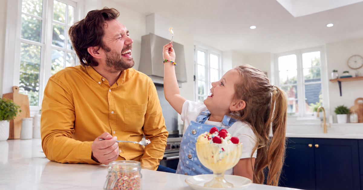 daughter-feeding-ice-cream-to-dad