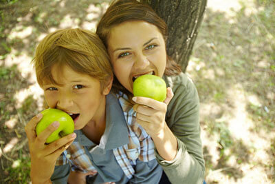 Mom and son eating apple