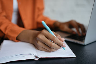 woman writing in a notebook