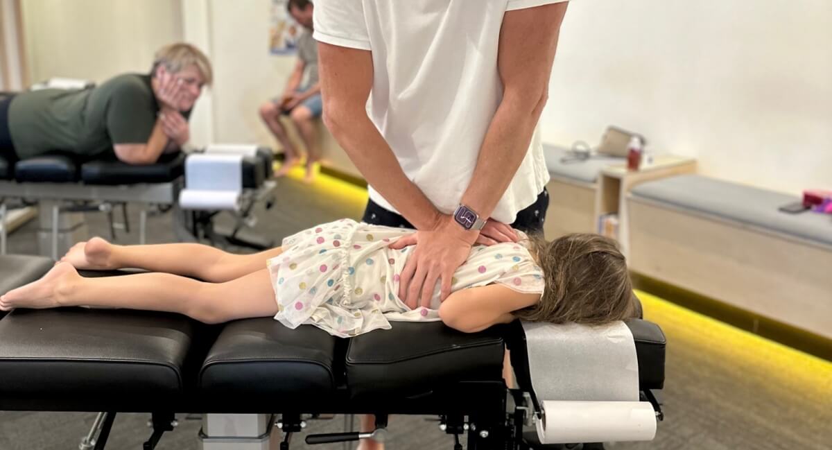 Young child receiving a chiropractic adjustment at Peak Potential Chiropractic