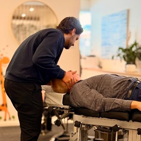 Gentle chiropractic neck adjustment for male patient