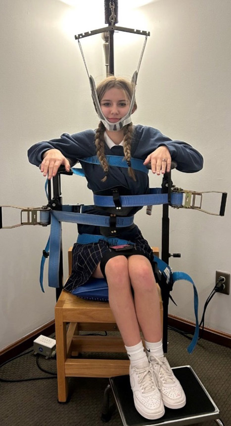 young female patient on scoli chair smiling