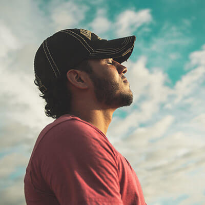 smiling person breathing calmly at sunset