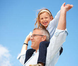 Grandaughter on grandfather's shoulders