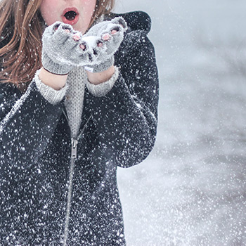 woman playing in winter snow