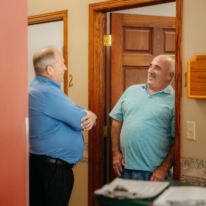 Dr John talking with patient