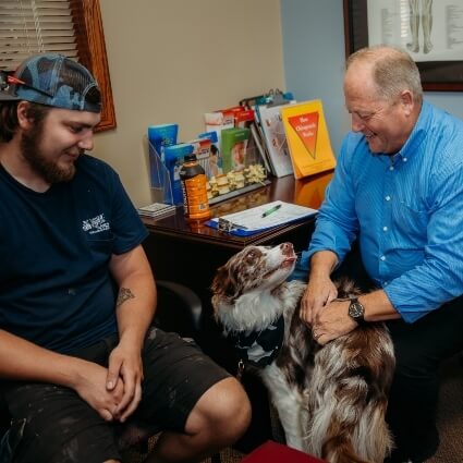 Dr John talking with patient and his pet