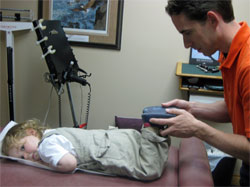 Dr. Bradley Jutzi adjusts a young patient Dr. Bradley Jutzi adjusts a young patient