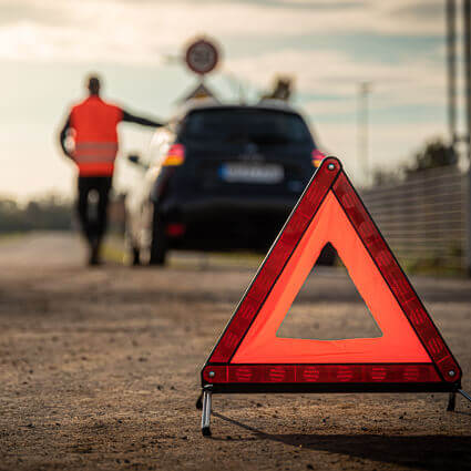 orange warning device behind the car