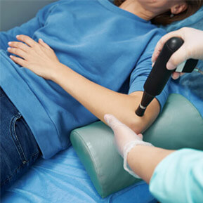 Shockwave wand on elbow, highlighting Shockwave therapy services at Parkview Chiropractic, Chiropractor Oakdale MN.