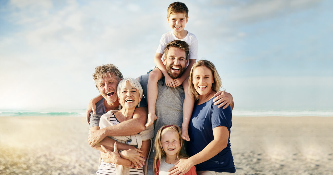 family smiling on beach