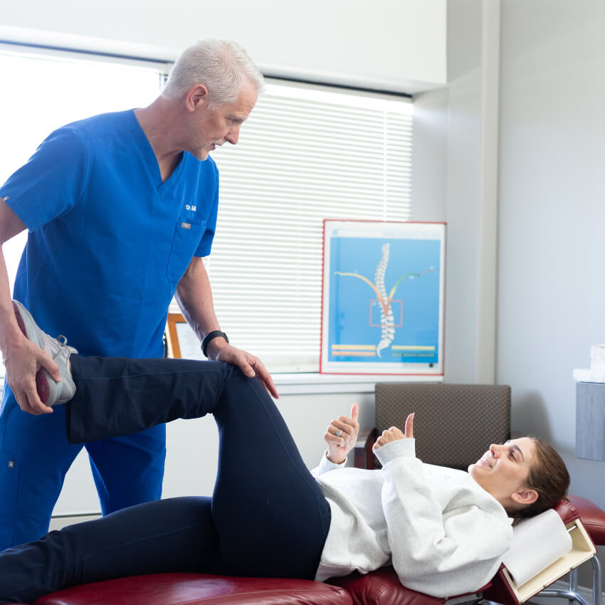 Dr Ron adjusting patients leg