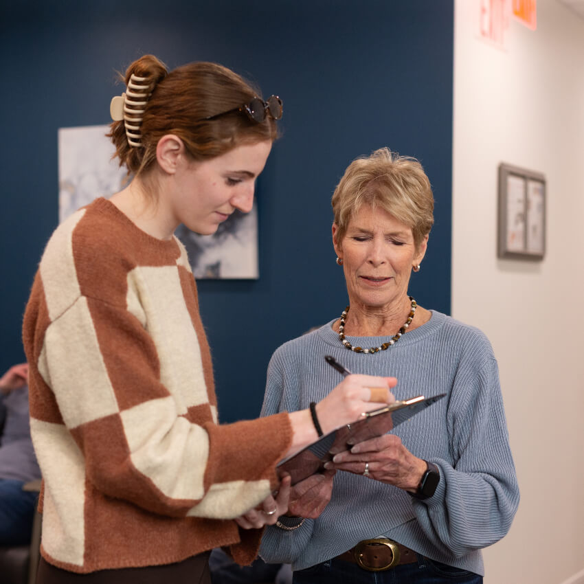 patient being handed paperwork