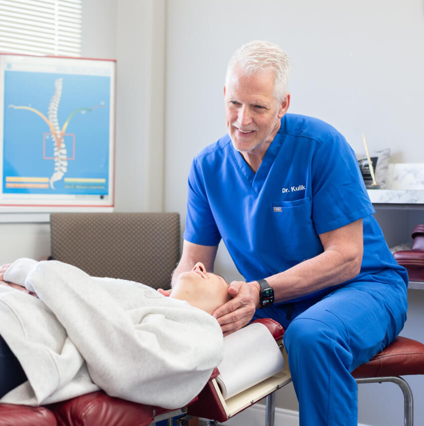 Dr Ron adjusting patients neck