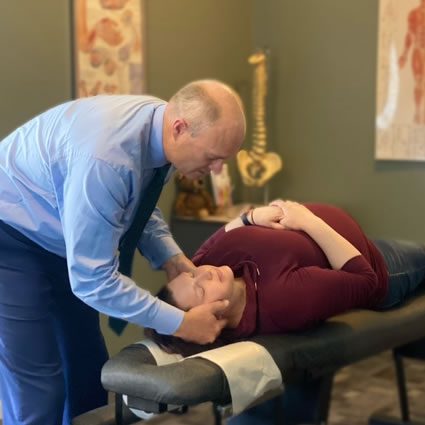 Dr. Steve adjusting pregnant woman