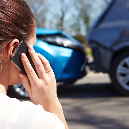 woman on cell phone after car accident