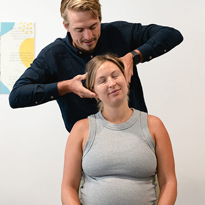 chiropractor adjusting patients neck