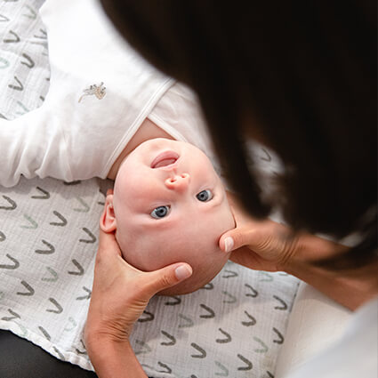 Baby looking up at doctor