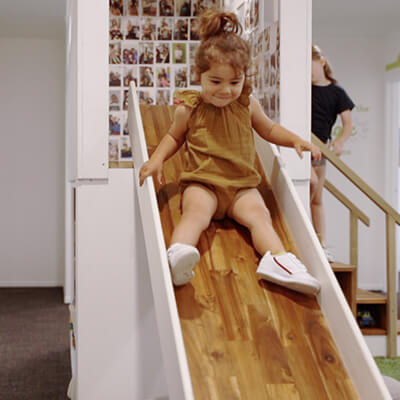 child playing on slide