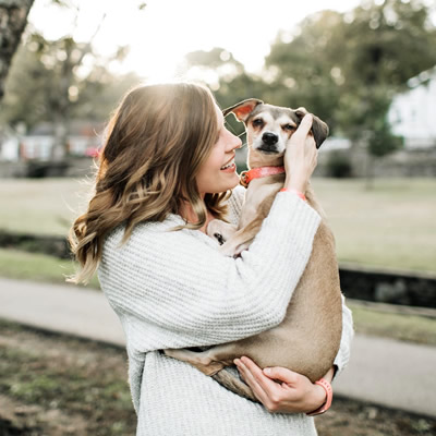 woman carries her dog