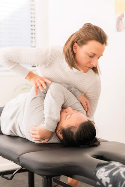 female practitioner arms crossed adjustment