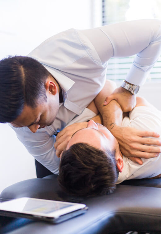 Chiropractor adjusting patient