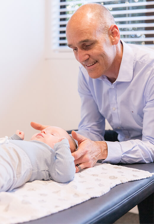 Chiropractor adjusting baby