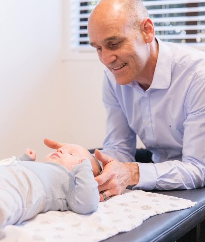 Chiropractor adjusting baby