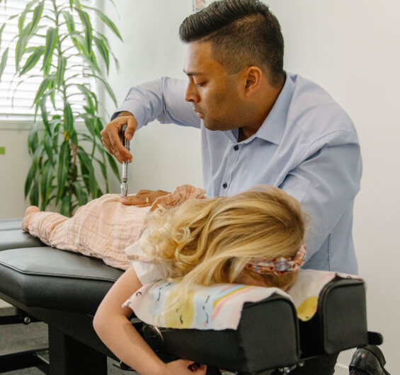 Chiropractor adjusting kid