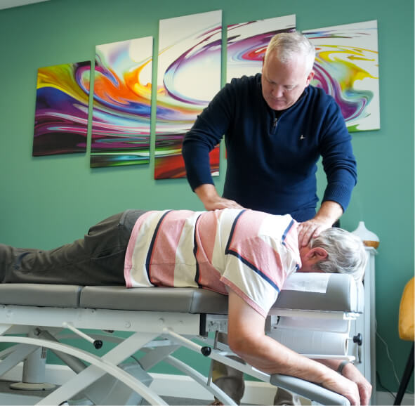 Chiropractor adjusting patient back