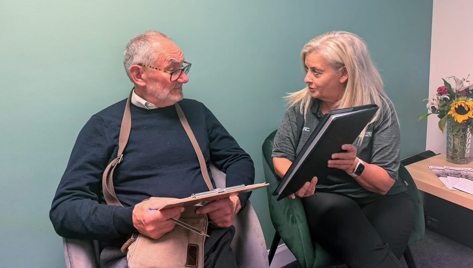 Chiropractor talking to patient