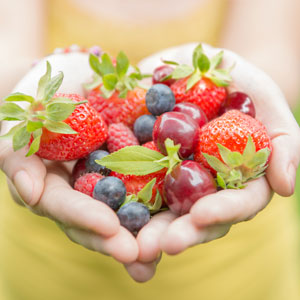 hands holding fruit