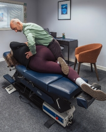 Chiropractor treating patient's lower-back