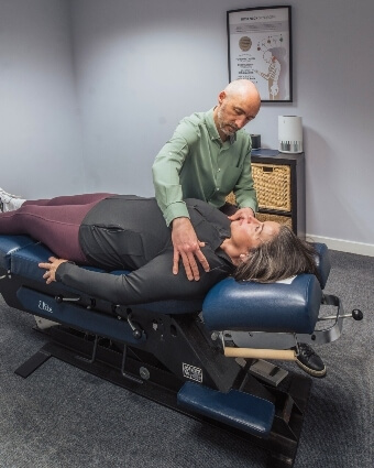Female patient receiving chiropractic shoulder asjustment