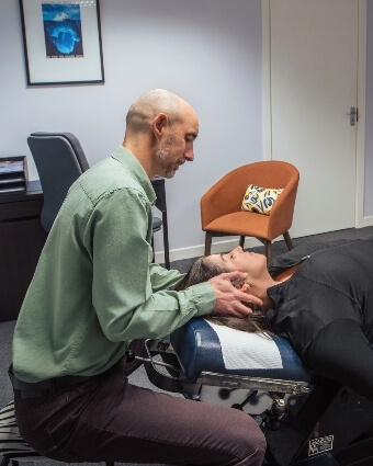 Dundalk chiropractor Dr. Kelly adjusting patient's neck