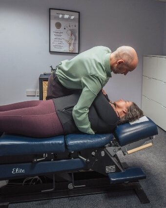 Female patient treated with chiropractic adjustment