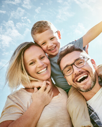 Smiling family of three