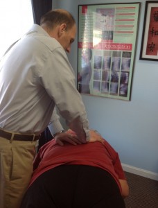 Dr. Randy Frederick adjusting his patient.