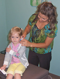 Doctor checking childs ears