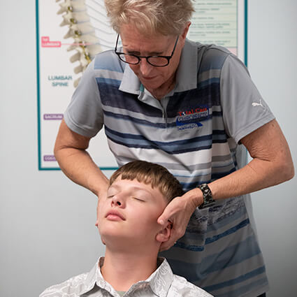 Total Care Chiropractic Dr Denise adjusting kids neck