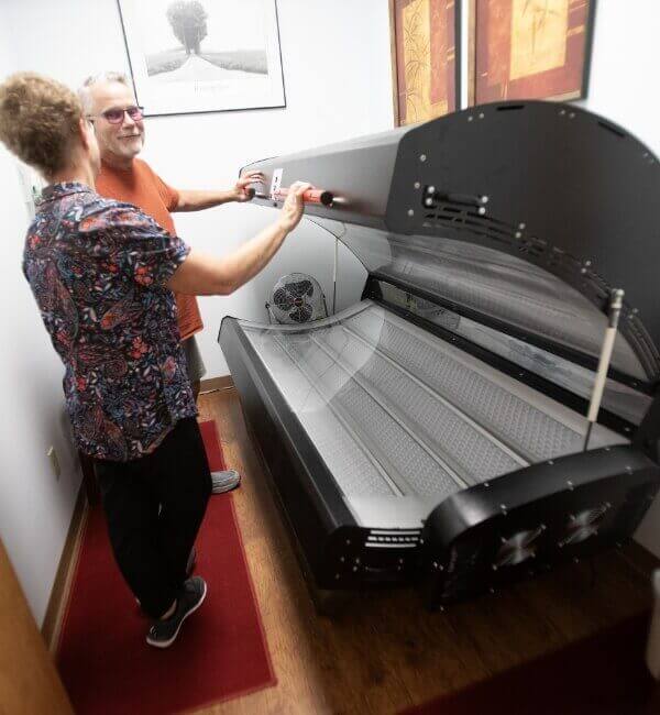 Total Care Chiropractic patient looking at red light therapy bed