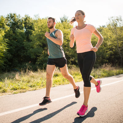 Man and woman jogging on road