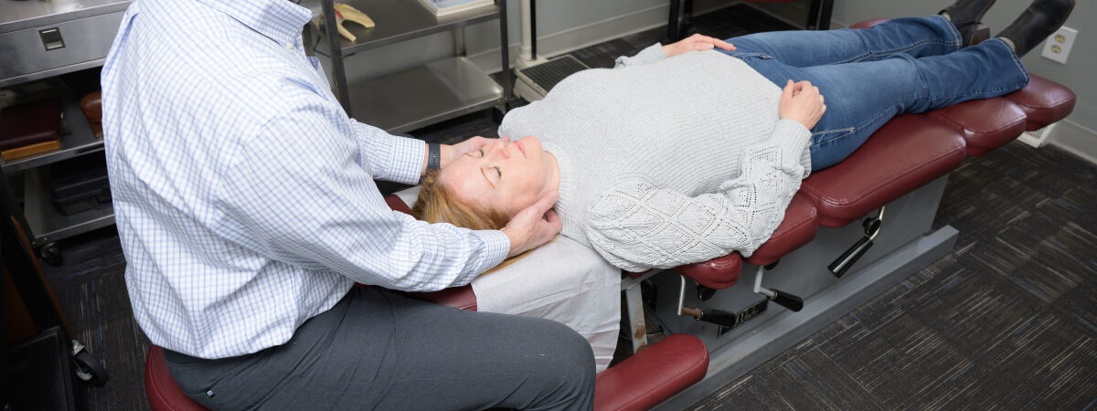 Vernon chiropractor adjusting a female patient's back