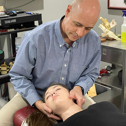 Dr. G adjusting a patients neck