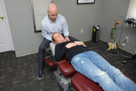 Female patient getting her neck adjusted