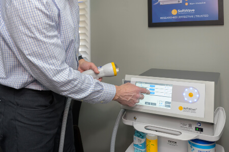 Vernon chiropractor preparing SoftWave Therapy equipment