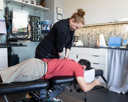 Chiropractic Care Male patient receiving back adjustment