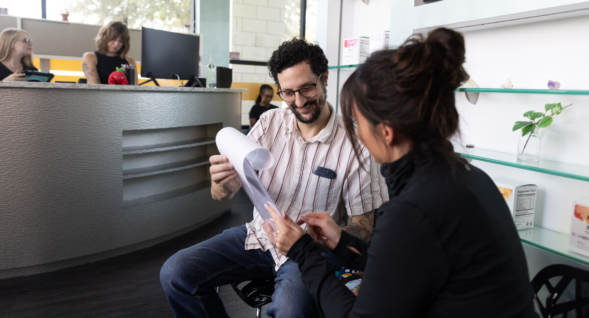Whole Family Chiropractors staff assisting patient with paperwork