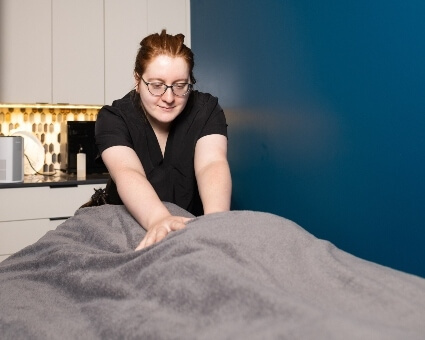 Myofascial Therapy Patient covered by towel receiving a massage